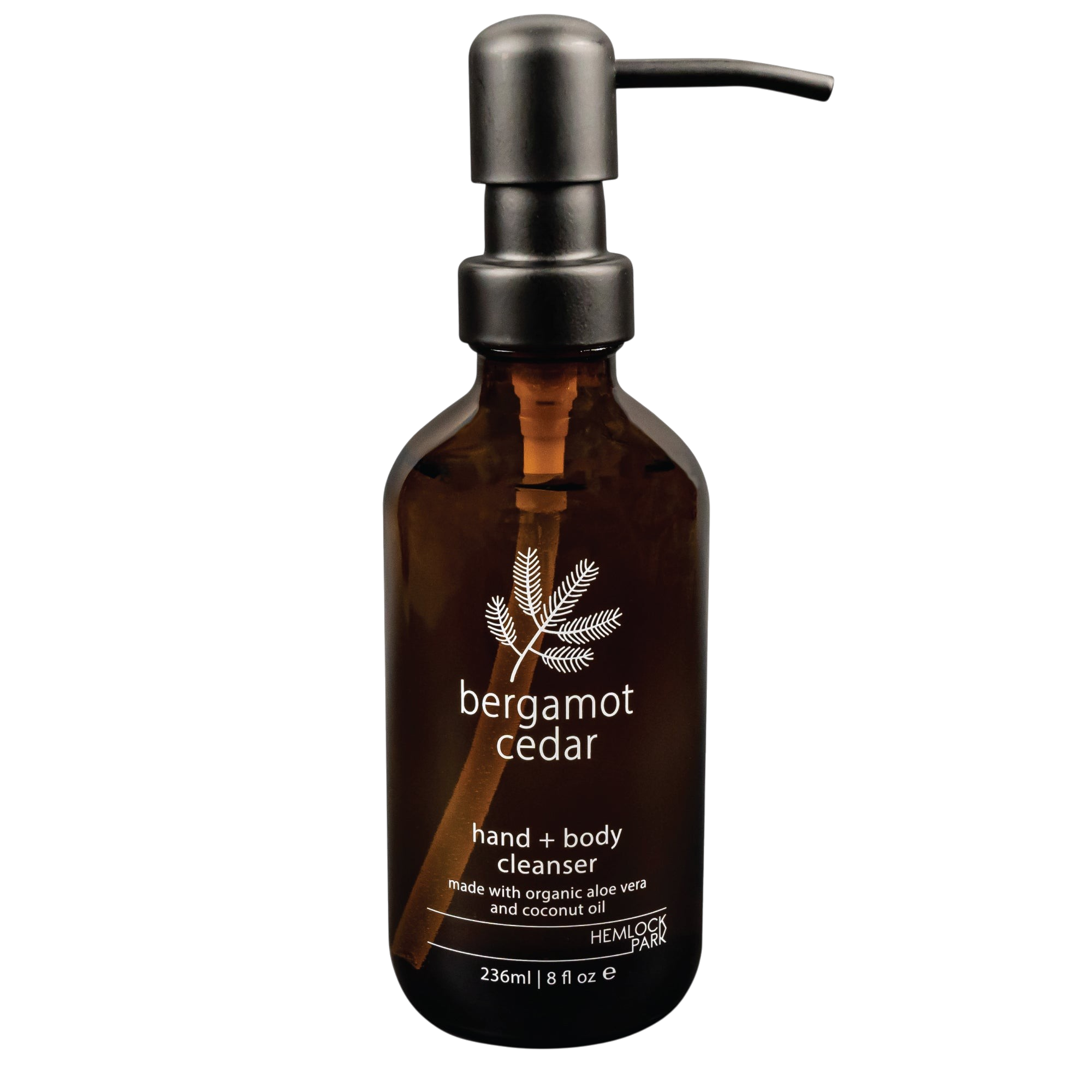 Hemlock Park Bergamot Cedar hand and body cleanser in an amber glass bottle with a black pump dispenser.