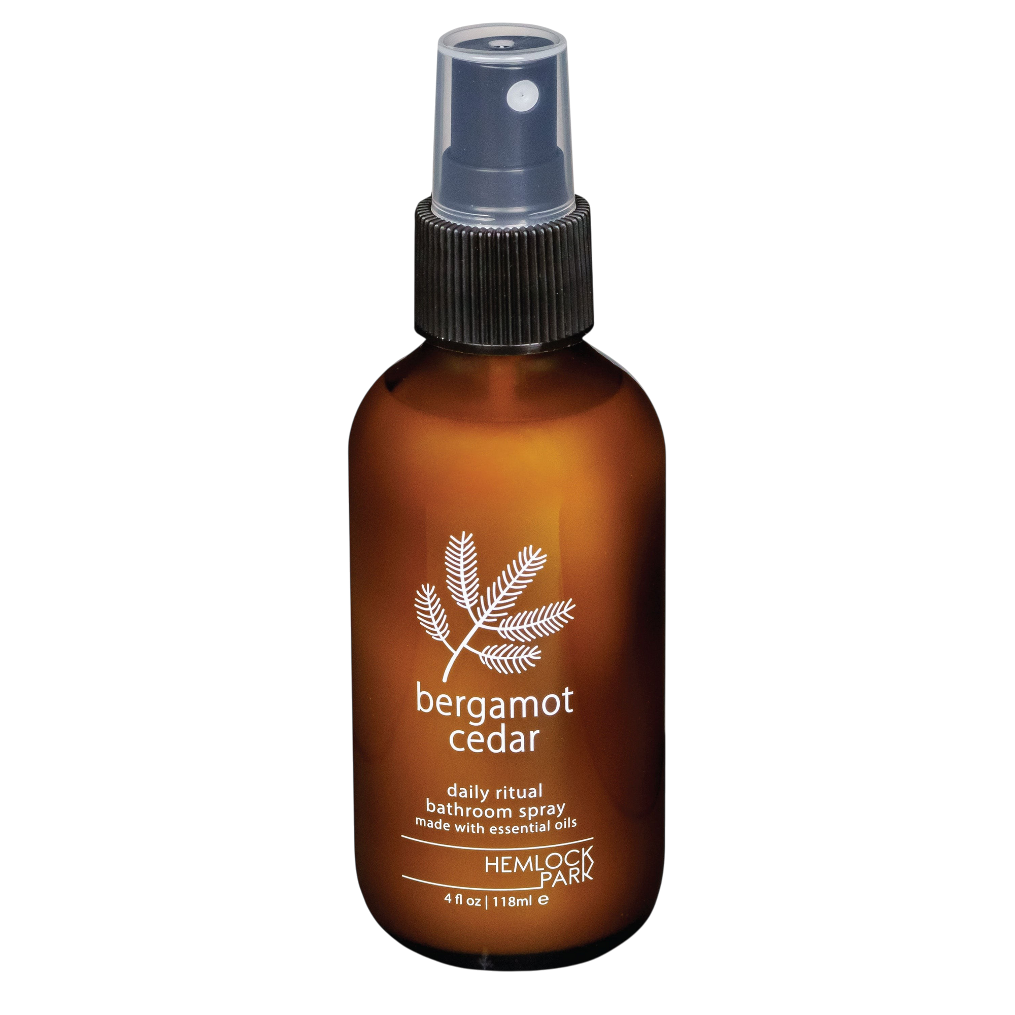 Hemlock Park Bergamot Cedar room spray in an amber glass bottle with a black spray nozzle and botanical label.