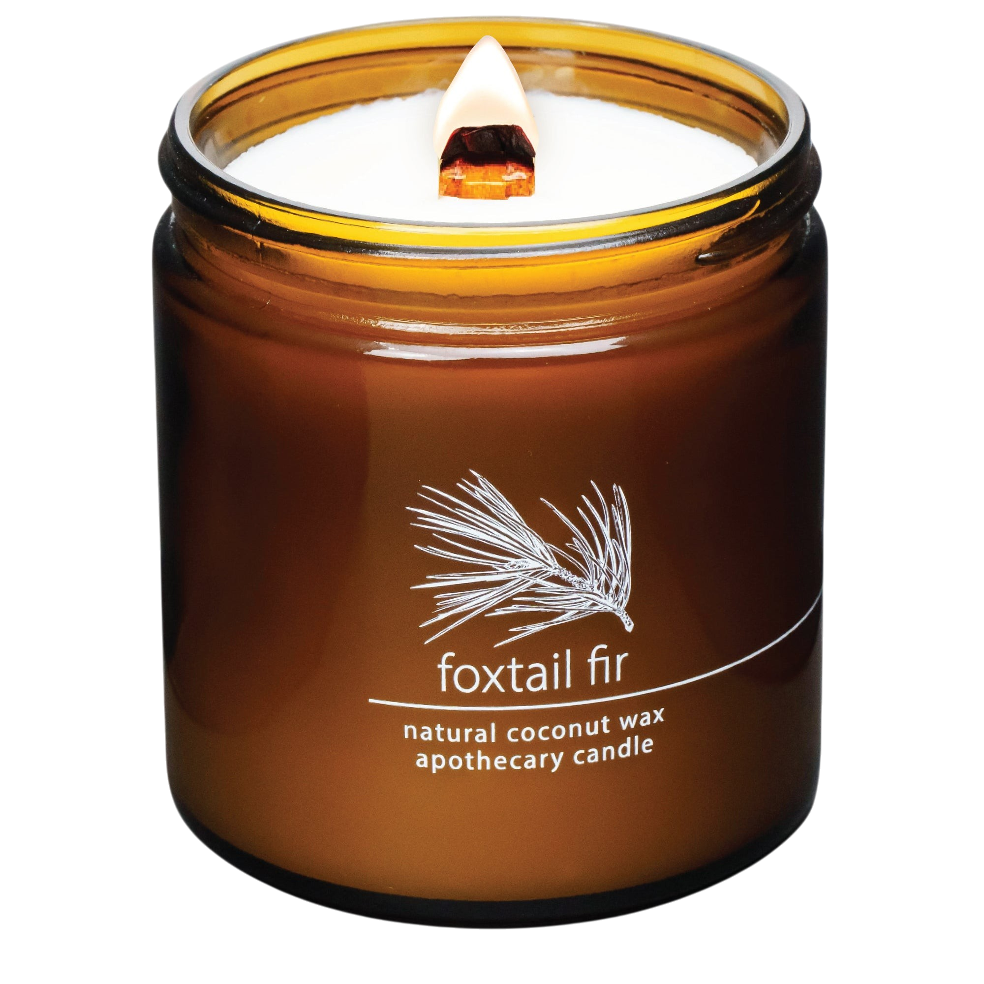 Hemlock Park Foxtail Fir apothecary candle in an amber glass jar with a lit wooden wick and botanical label.