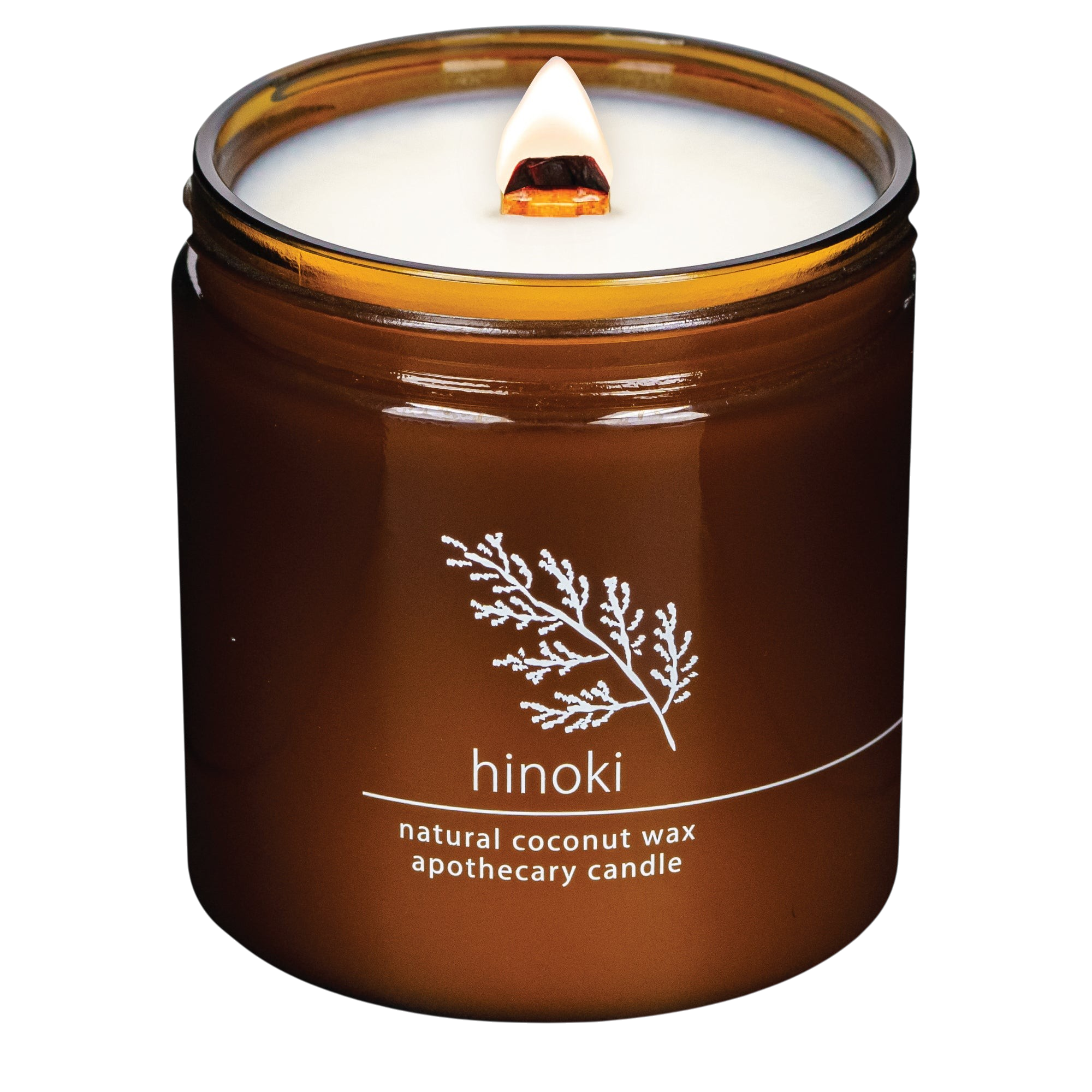 Hemlock Park Hinoki apothecary candle in an amber glass jar with a lit wooden wick and botanical label design