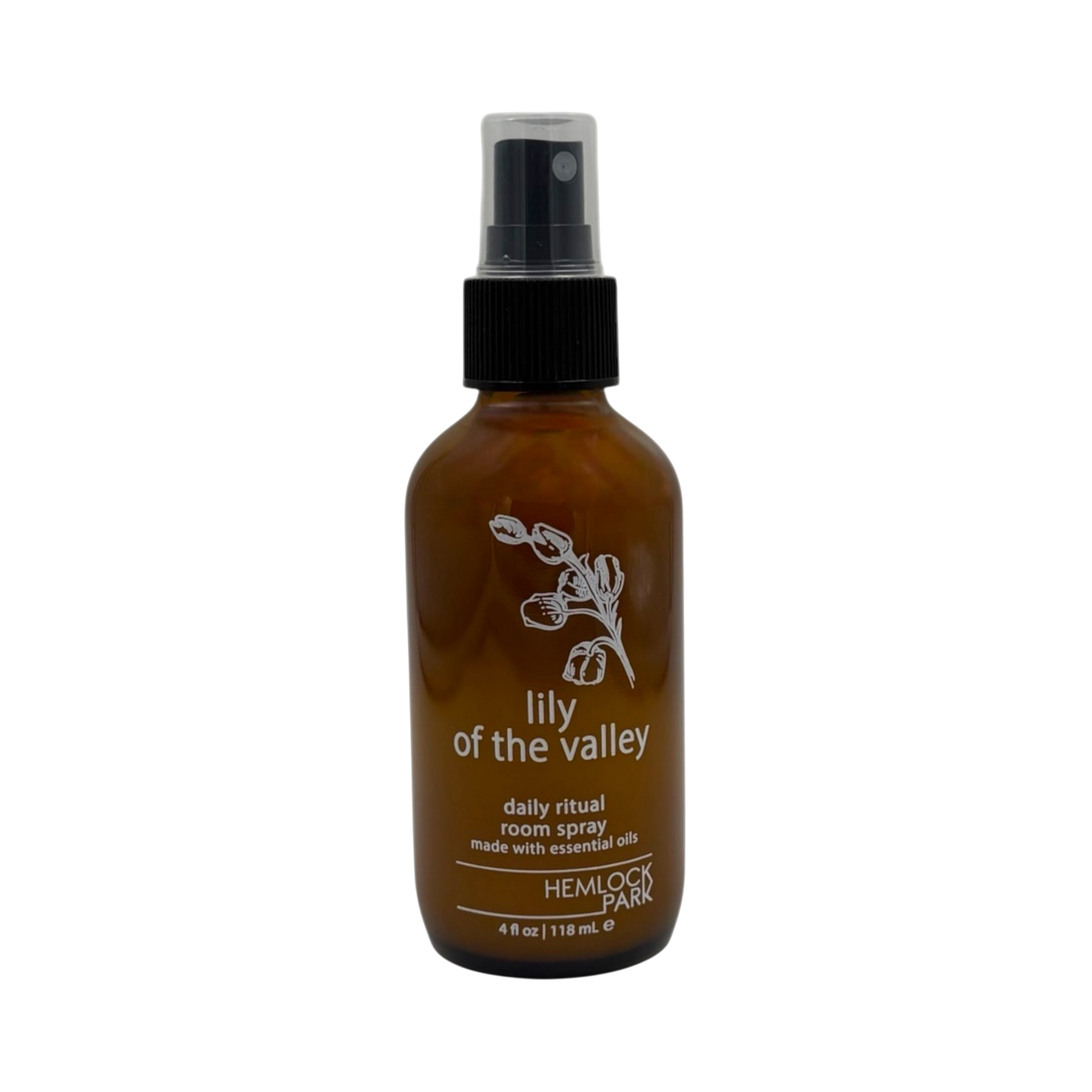 Hemlock Park Lily of the Valley room spray in an amber glass bottle with a black spray nozzle.