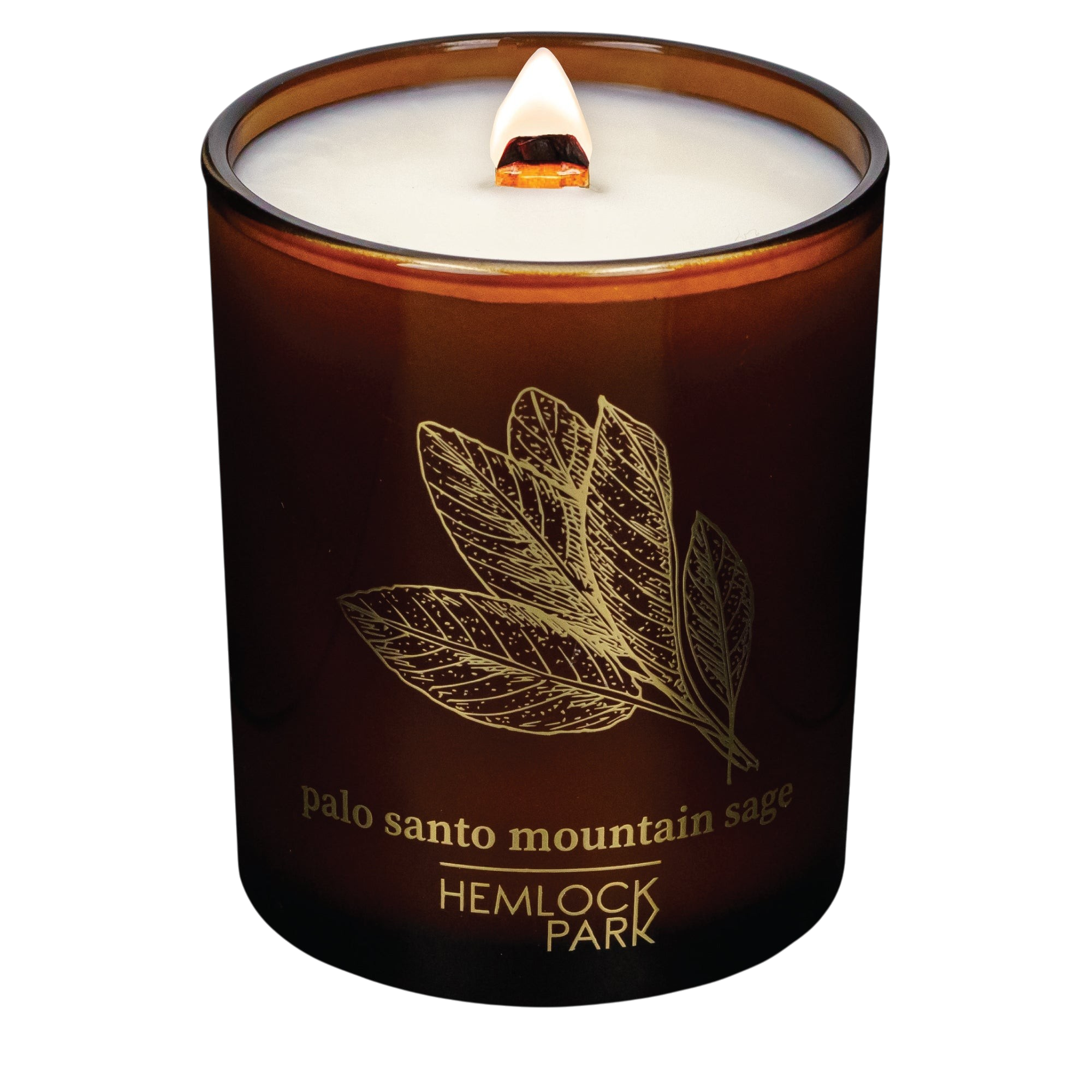 Hemlock Park Palo Santo Mountain Sage candle in an amber glass jar with a lit wooden wick and gold leaf design.