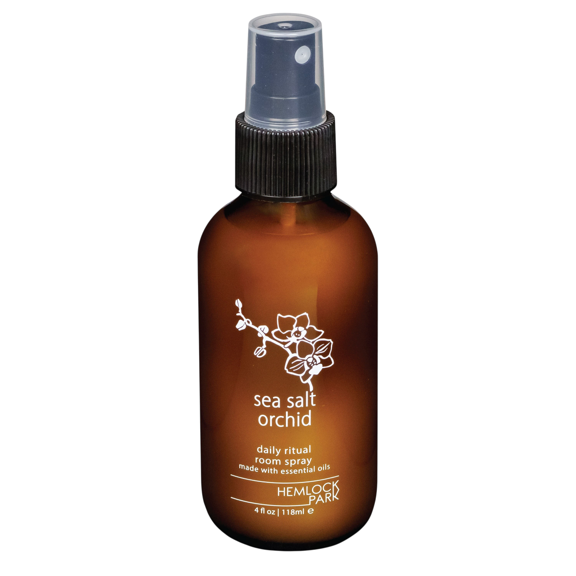 Hemlock Park Sea Salt Orchid room spray in an amber glass bottle with a black spray nozzle and floral label design.