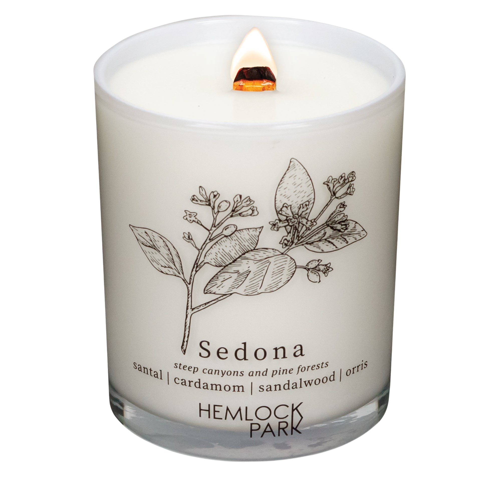 Hemlock Park Sedona Postcards candle in a white glass jar with a botanical illustration and wooden wick